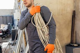 worker-with-hard-hat-carrying-rope--1-