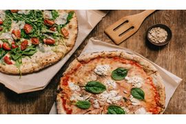 top-view-of-tasty-italian-pizzas-on-wooden-tableto-2023-11-27-04-58-26-utc--1-