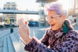 senior-woman-with-colorful-hair-taking-a-selfie-in-2024-07-05-19-25-41-utc--1-