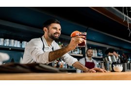 smiling-bartender-serving-cocktail-at-wooden-count-2023-11-27-05-32-43-utc--2-