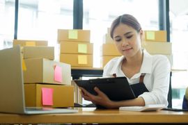 young-asian-businesswoman-onwer-checking-parcels-l-2023-11-27-05-19-59-utc