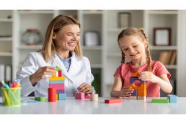 child-development-specialist-playing-wooden-bricks-2023-11-27-05-34-12-utc--1-