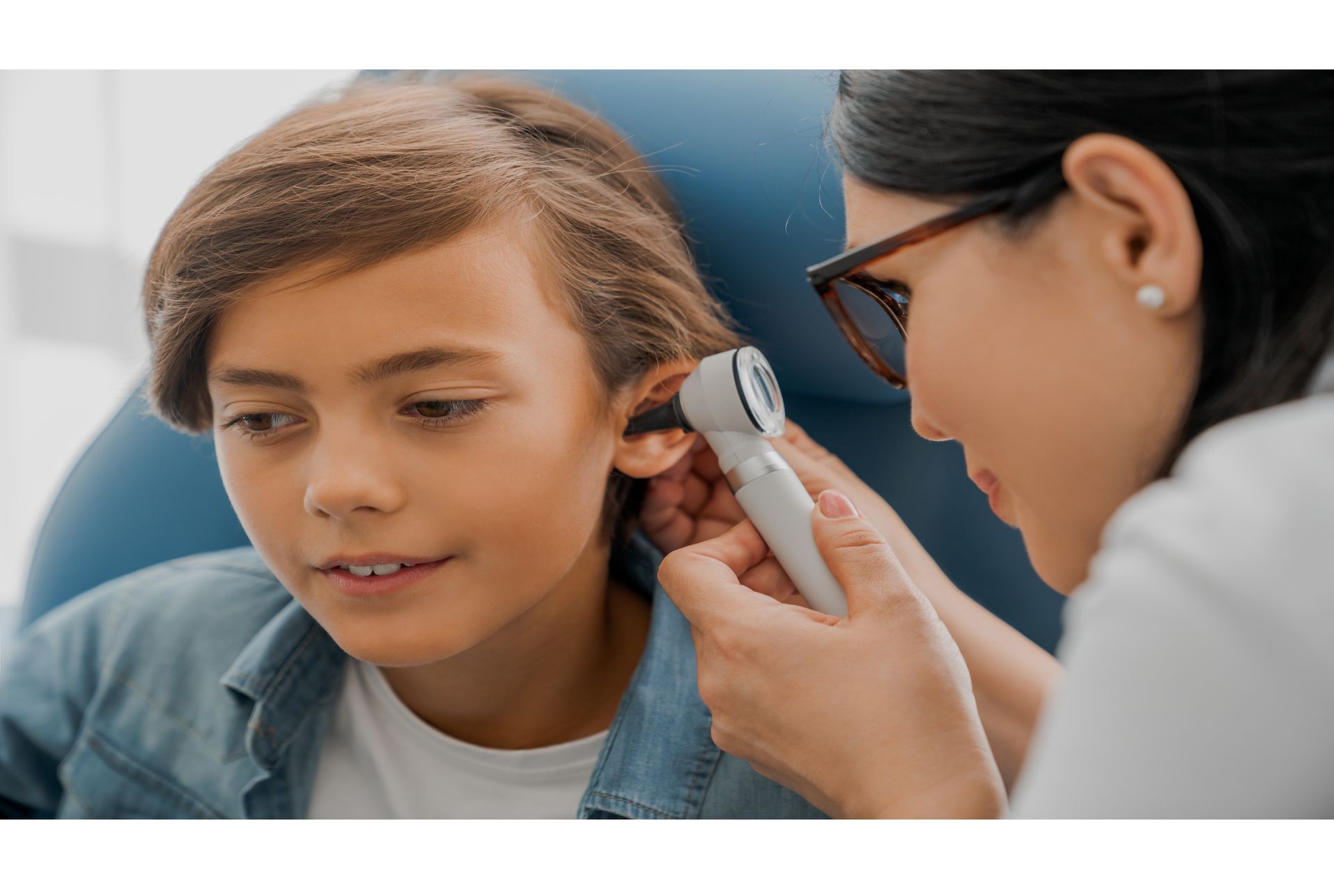 female-doctor-examining-boy-s-ear-with-otoscope-2023-11-27-05-16-55-utc--1-