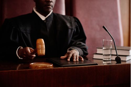 focus-on-wooden-gavel-in-hand-of-experienced-male-2023-11-27-05-07-03-utc--1-