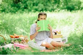 teen-girl-reads-a-book-in-the-park-on-the-nature-2024-10-11-15-17-46-utc--1-