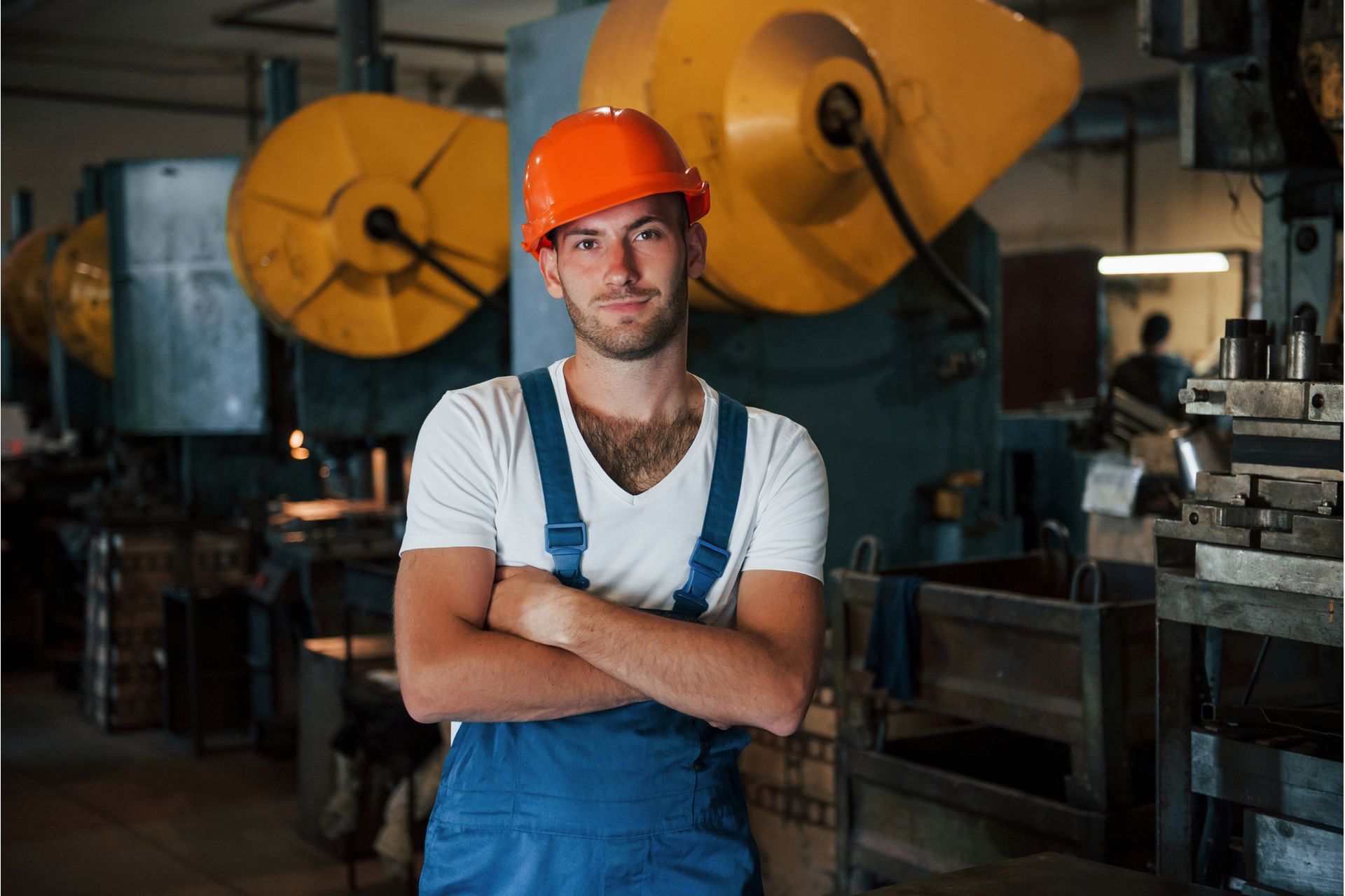 big-production-machine-behind-portrait-of-enginee-2023-11-27-05-36-20-utc--1-