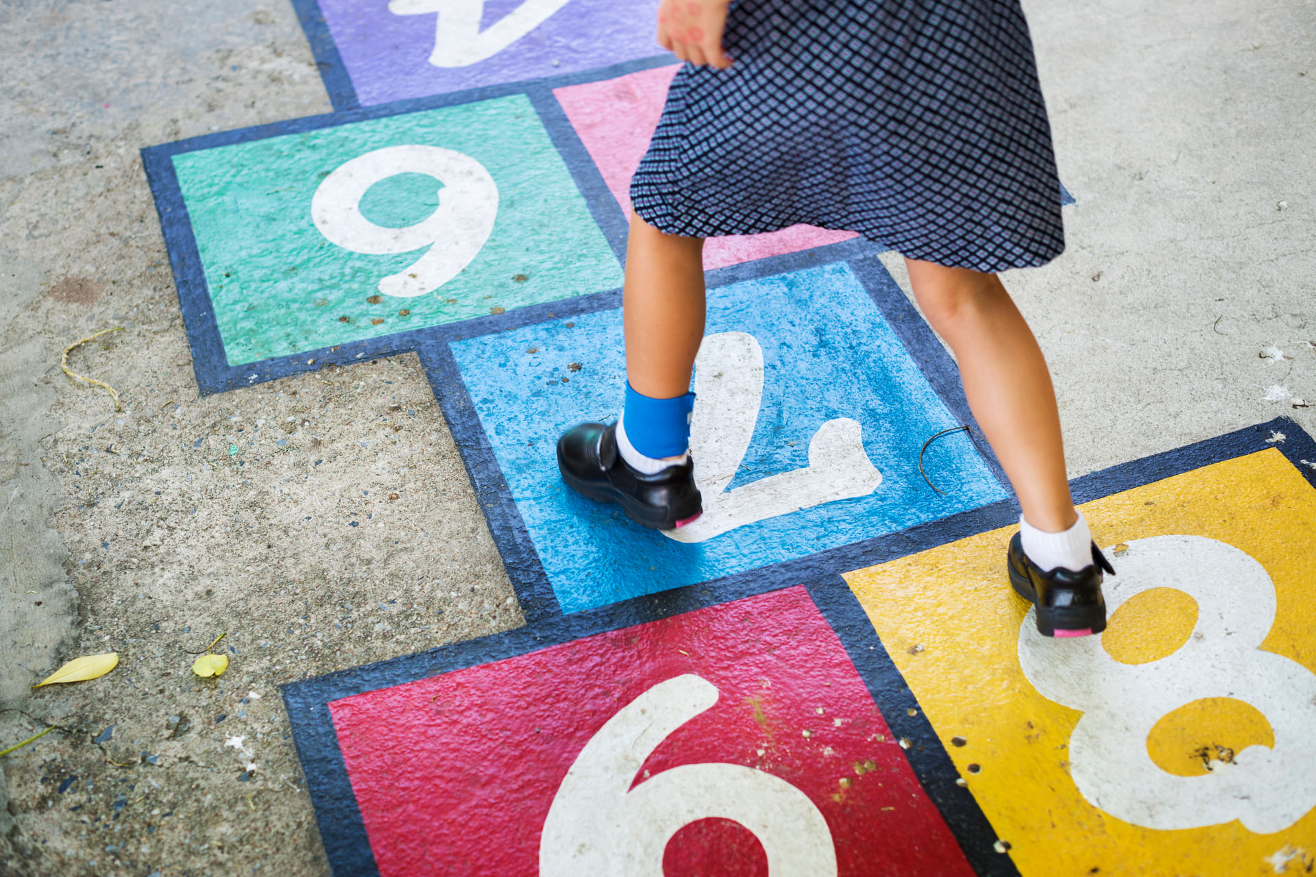 young-girl-playing-hopscotch-2023-11-27-05-23-12-utc--1-.jpg