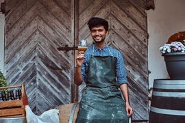 brewmaster-sitting-on-wooden-barrel-and-holds-a-gl-2023-11-27-04-58-58-utc--1-.jpg